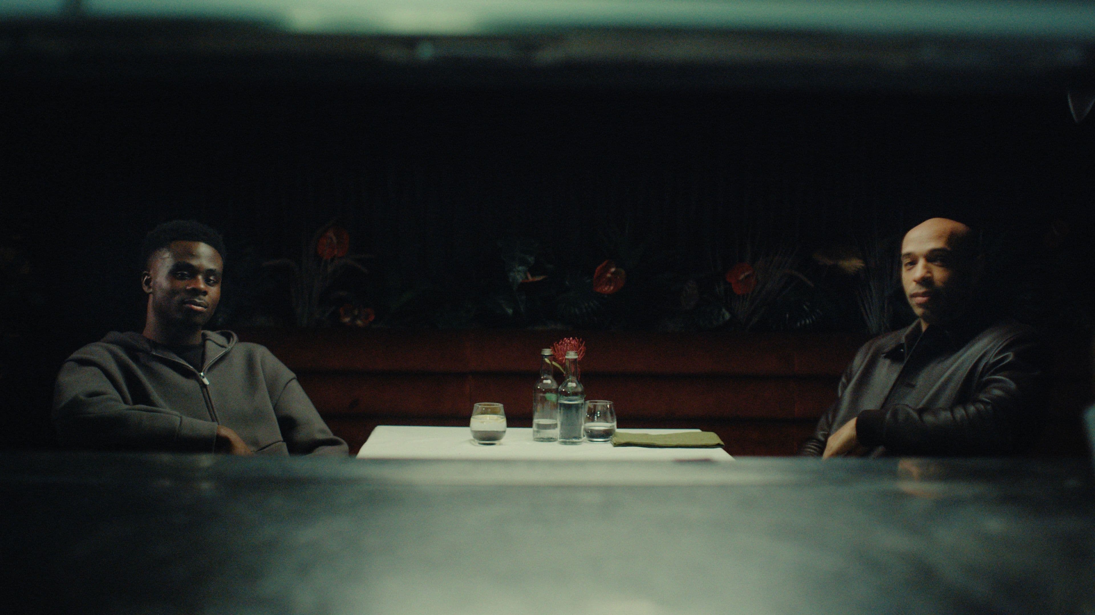two men looking at camera at dinner table