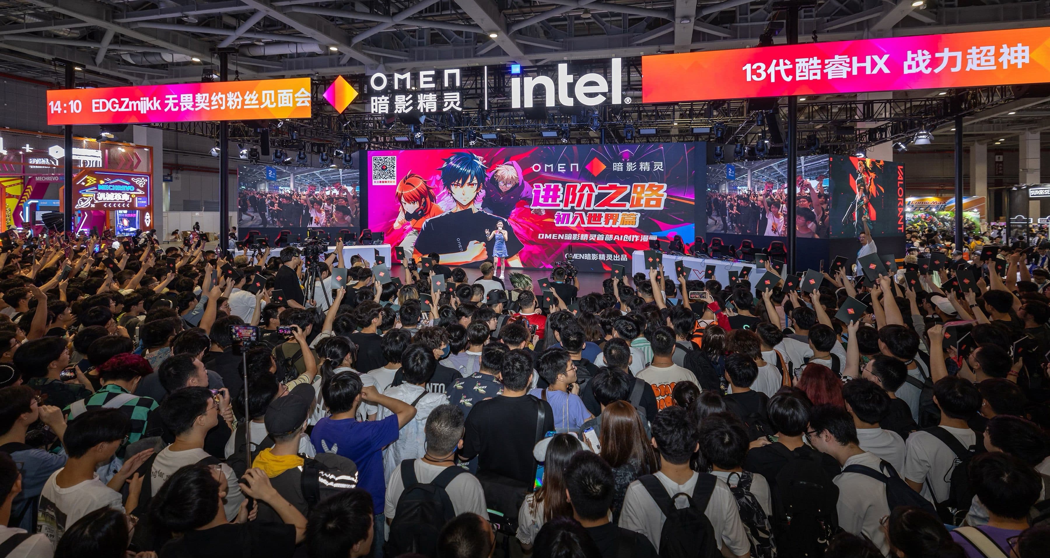 Crowd at a tech event with a large screen displaying anime characters and logos. Bright lights and banners.