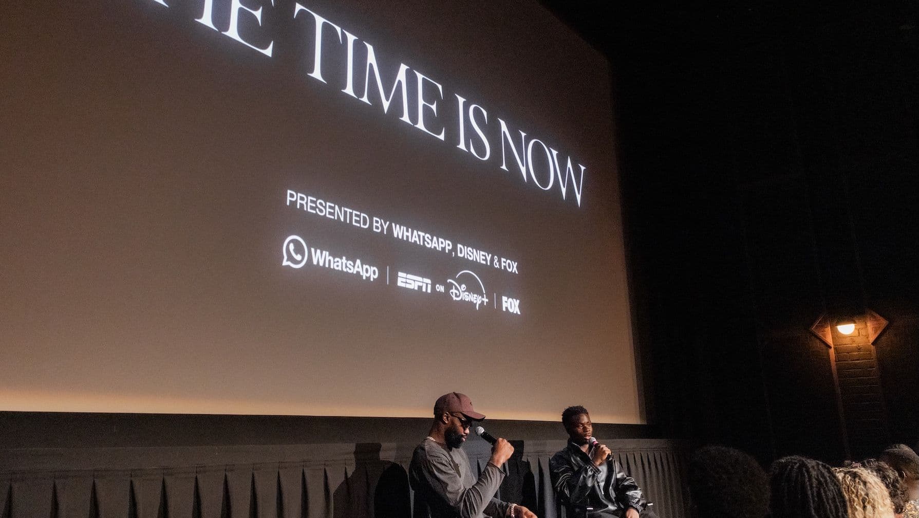 two men in front of film screen