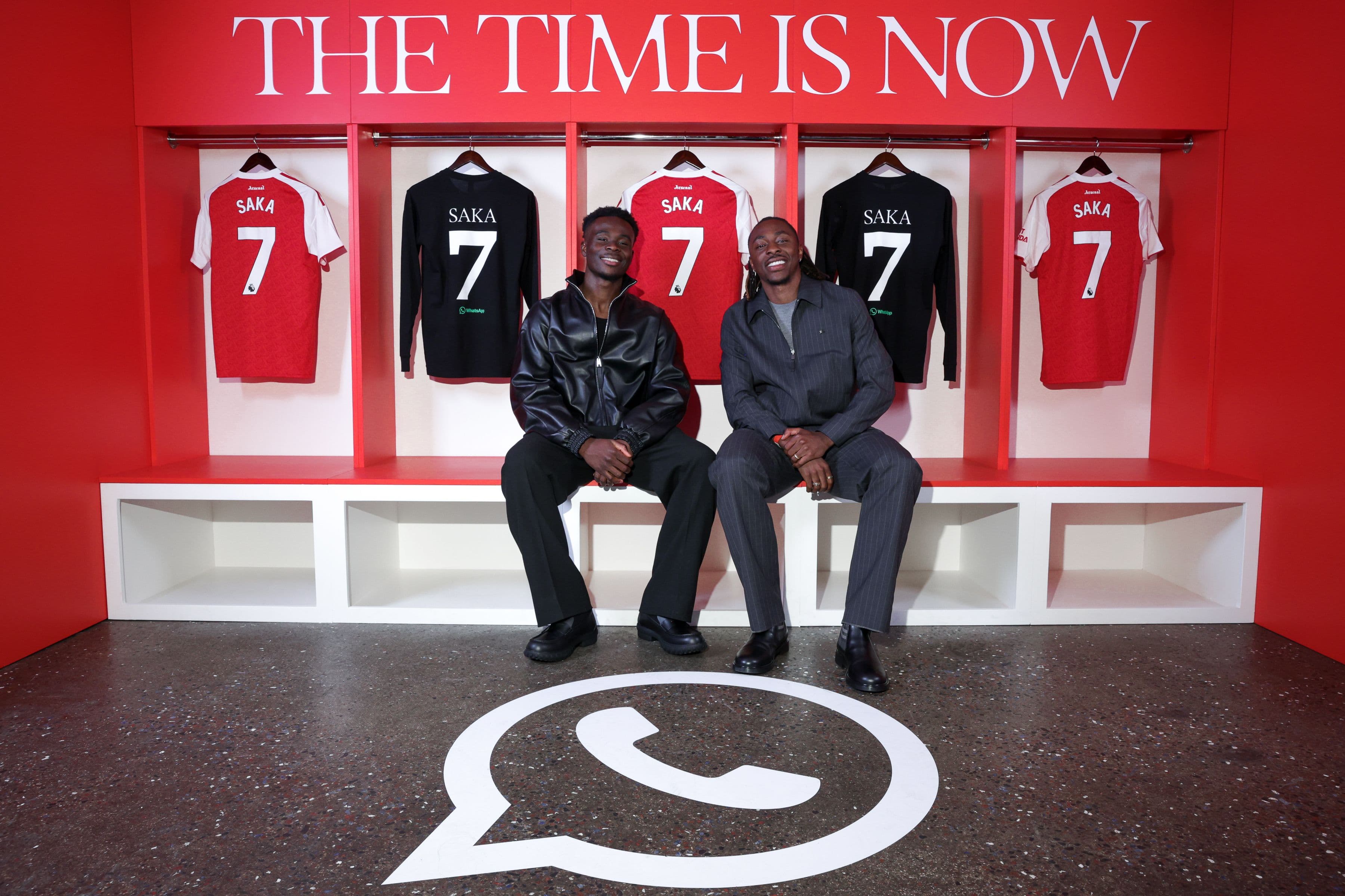 two soccer players in front of jerseys